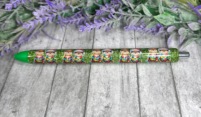 Handmade Christmas Otters on green glitter pen with free refill